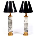 A PAIR OF CYLINDRICAL TABLE LAMPS with turned gilt mounts in the manner of Fornasetti with black