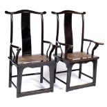 A PAIR OF MING STYLE BLACK LACQUERED THRONE CHAIRS with curving vertical splats, cane seats and