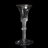 AN 18TH CENTURY WINE GLASS with waited conical bowl and air twist decoration to the stem with