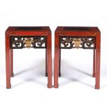 A PAIR OF CHINESE RED LACQUERED SQUARE TOPPED URN STANDS with pierced parcel gilt friezes 39.5cm