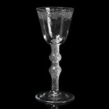 AN 18TH CENTURY WINE GLASS with flower and fruiting vine engraved decoration in a band to the bell