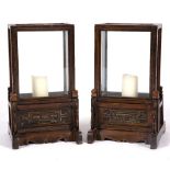 A PAIR OF CHINESE CANDLE STANDS the rectangular section, glazed four sides, and with carved panels