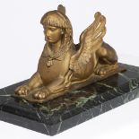 A LATE 19TH / EARLY 20TH CENTURY GILT METAL SCULPTURE OF A SPHINX on a green marble plinth, 49cm