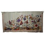 AN EARLY 20TH CENTURY CREWEL WORK EMBROIDERED PANEL worked in coloured threads on linen,