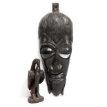 AN EARLY 20TH CENTURY CARVED EBONY MASK 92cm in length and an early to mid 20th Century soft wood