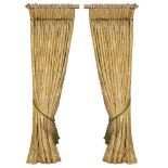 A PAIR OF GOLD GROUND INTERLINED CURTAINS decorated with green branches and yellow and gold flowers,