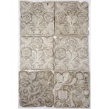 A SET OF SIX ARTS & CRAFTS MOULDED PLASTER TILES of flower head designs, each 20cm wide x 22cm high