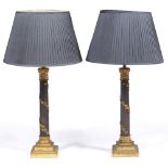 A PAIR OF GEORGIAN STYLE GILT AND EBONISED TABLE LAMPS in the form of classical columns with