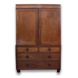 AN EARLY VICTORIAN MAHOGANY LINEN PRESS with twin panel doors opening to reveal three sliding