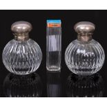 A PAIR OF SILVER MOUNTED CUT GLASS OVOID SCENT BOTTLES together with an enamel and silver lidded