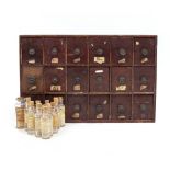 A VINTAGE PHARMACY OR APOTHECARY EIGHTEEN DRAWER CABINET with circular handles and a collection of