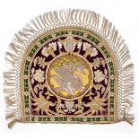 A CONTINENTAL SILVER AND GOLD THREAD EMBROIDERED SHIELD SHAPE PANEL depicting an eagle feeding