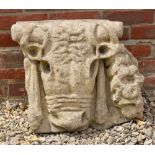 A CAST RECONSTITUTED STONE PLAQUE after the antique depicting a bull's head, approximately 53cm wide