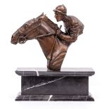 A BRONZE HEAD AND SHOULDER BUST OF A HORSE AND JOCKEY mounted on a marble plinth, 31cm wide x 38cm