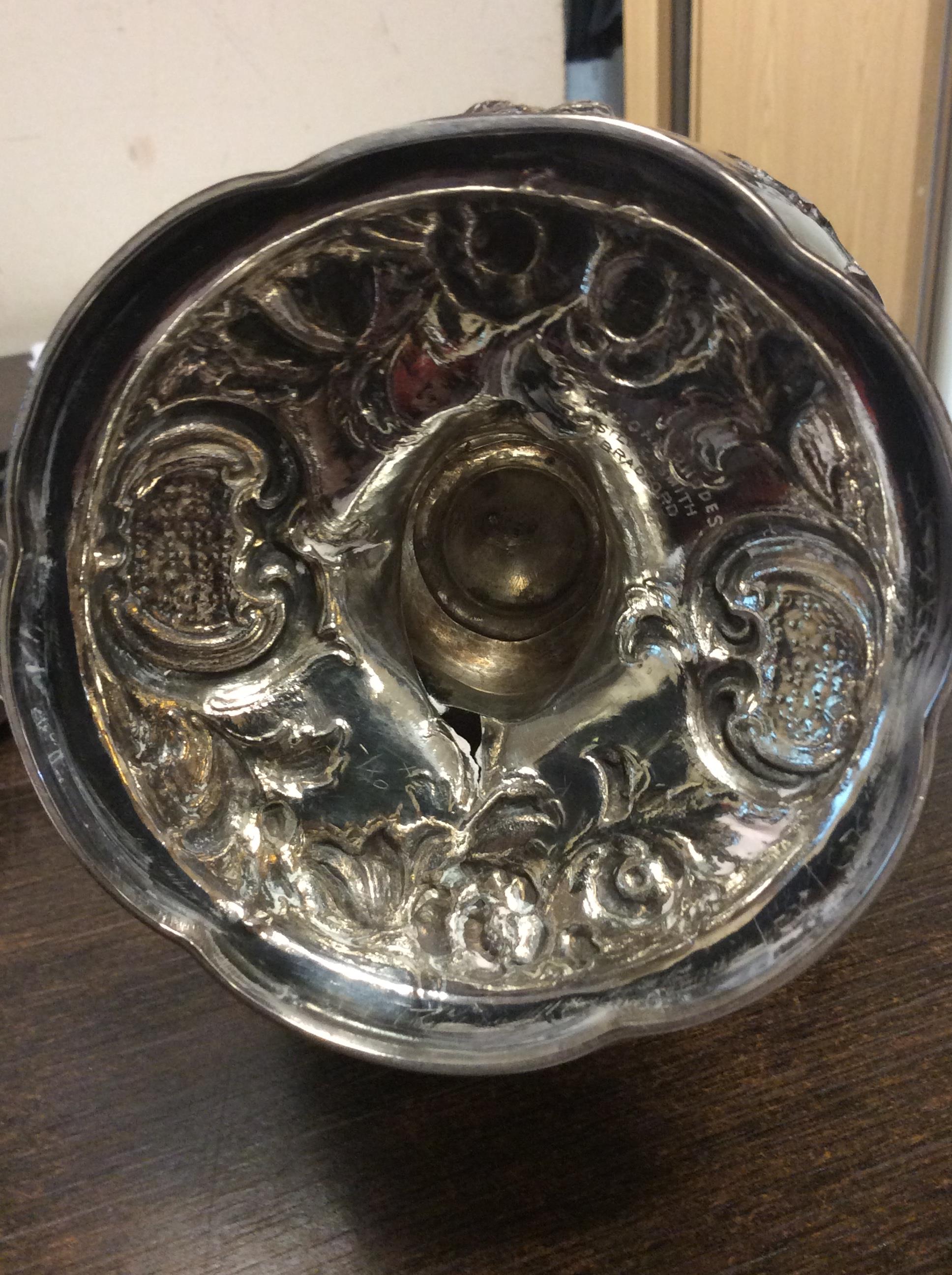 A VICTORIAN SILVER WATER JUG with repousse decoration and a scrolling handle on a circular base, - Image 4 of 10