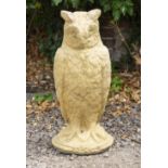 A CAST RECONSTITUTED STONE SCULPTURE OF AN OWL 69cm high
