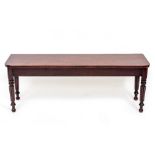A 19TH CENTURY GILLOWS STYLE MAHOGANY BENCH OR STOOL on reeded legs, 126cm wide x 46cm high x 33cm