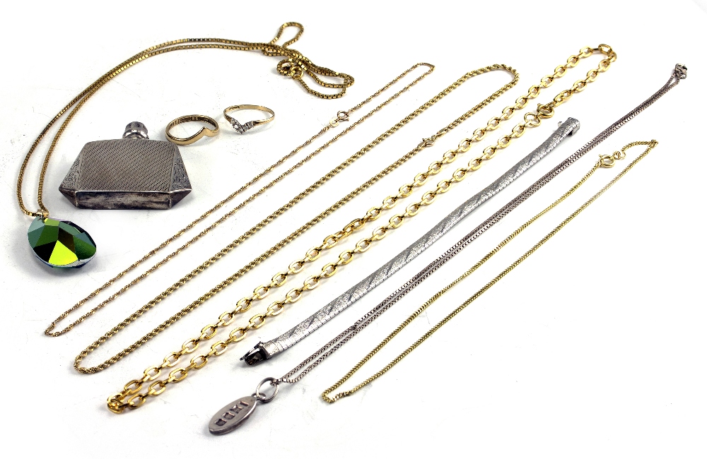 A COLLECTION OF JEWELLERY to include three 9 carat gold chains, two wishbone rings and a white metal