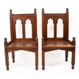 A PAIR OF ANTIQUE GOTHIC STYLE CHAIRS with shaped panel back standing on square legs and a Gothic