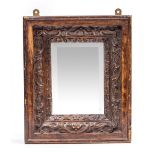 A SMALL CARVED OAK MIRROR 30cm x 36cm together with an old carving of a soldier, 45cm high (2)