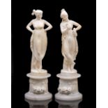 A NEAR PAIR OF 19TH CENTURY ALABASTER FIGURES of classical ladies on cylindrical plinths, each