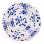 AN ANTIQUE DELFT BLUE AND WHITE PLATE with foliate scroll decoration, 26cm diameter