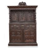 AN ANTIQUE 17TH CENTURY STYLE CARVED OAK COURT CUPBOARD, the three figural carved panel door with