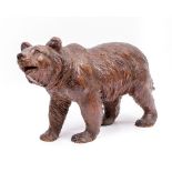 A CARVED WOODEN BLACK FOREST BEAR 40cm wide x 25cm high