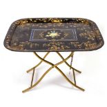 AN ANTIQUE TOLEWARE PAINTED TRAY decorated with gold and floral decoration on a gilt stand, the tray