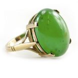 A 9 CARAT YELLOW GOLD MOUNTED JADE CABOCHON SET RING size O/P, 6.5 grams in weight approximately