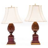 A PAIR OF 'BRIGHTS OF NETTLEBED' PAINTED COMPOSITE RED AND GILDED LAMPS in the form of pineapples,