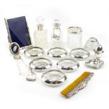 A COLLECTION OF SILVER to include two silver collared bottles, photoframes, ashtray, pair of