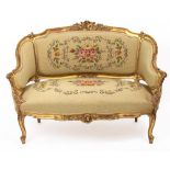 AN ANTIQUE FRENCH GILT PAINTED TWO SEATER SETTEE with tapestry upholstered seat, 123cm wide x 56cm