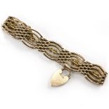 A 9 CARAT GOLD FANCY LINK GATE BRACELET with heart padlock clasp, 21 grams in weight approximately