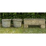 A PAIR OF RUSTICATED CONCRETE CYLINDRICAL PLANT POTS 59cm high overall and trough and an