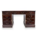 A PEDESTAL DESK with red leather inset top, 152cm wide x 91cm deep