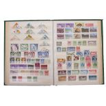 A GREEN ALBUM OF STAMPS to include GB, Commonwealth definitives and commemoratives sets, mostly used