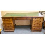 A VICTORIAN MAHOGANY KNEEHOLE DESK with green inset leather top, standing on a plinth base, 183cm