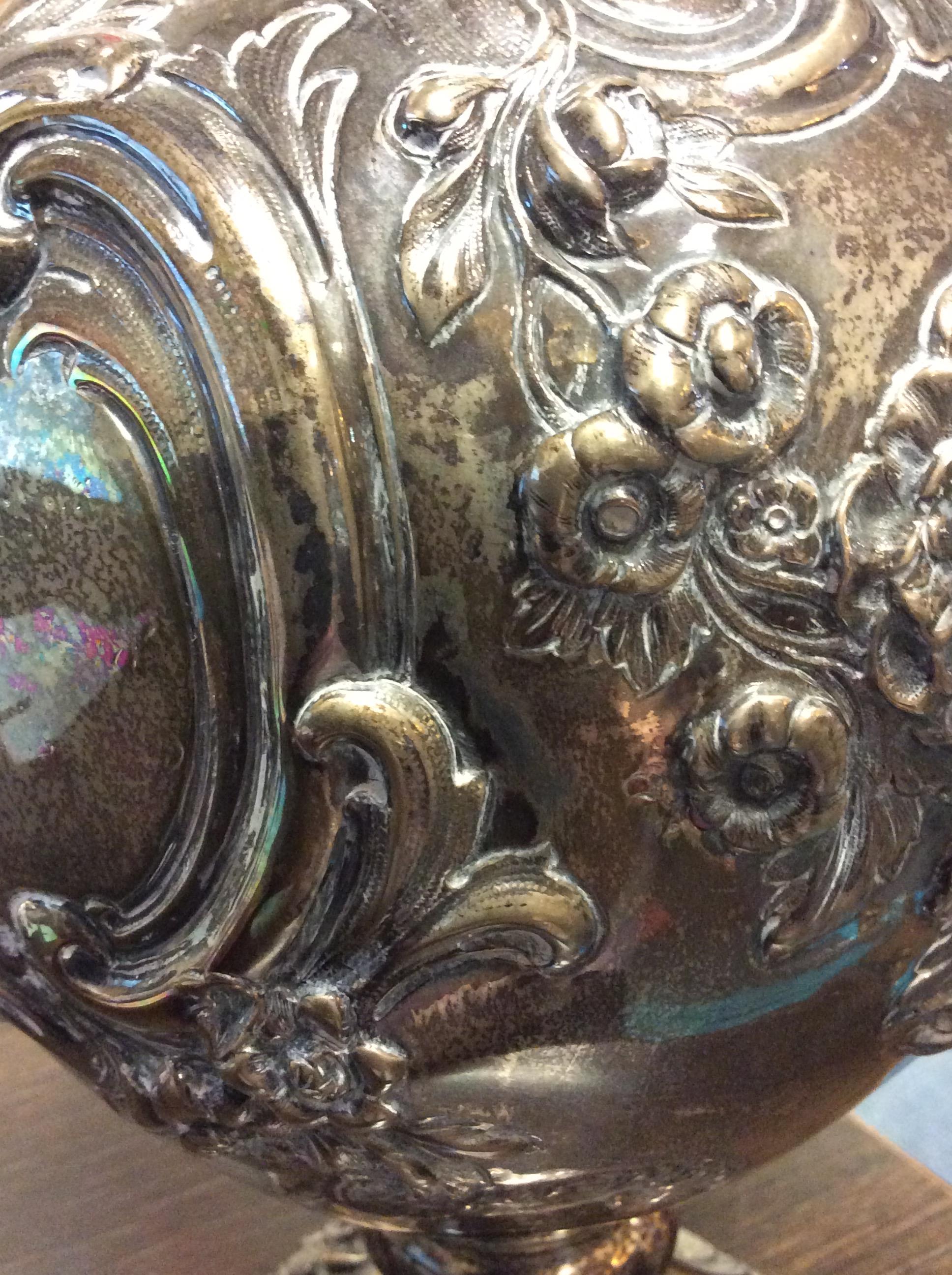 A VICTORIAN SILVER WATER JUG with repousse decoration and a scrolling handle on a circular base, - Image 10 of 10