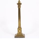 AN ANTIQUE BRASS TABLE LAMP originally an oil lamp base later converted to electric use in the