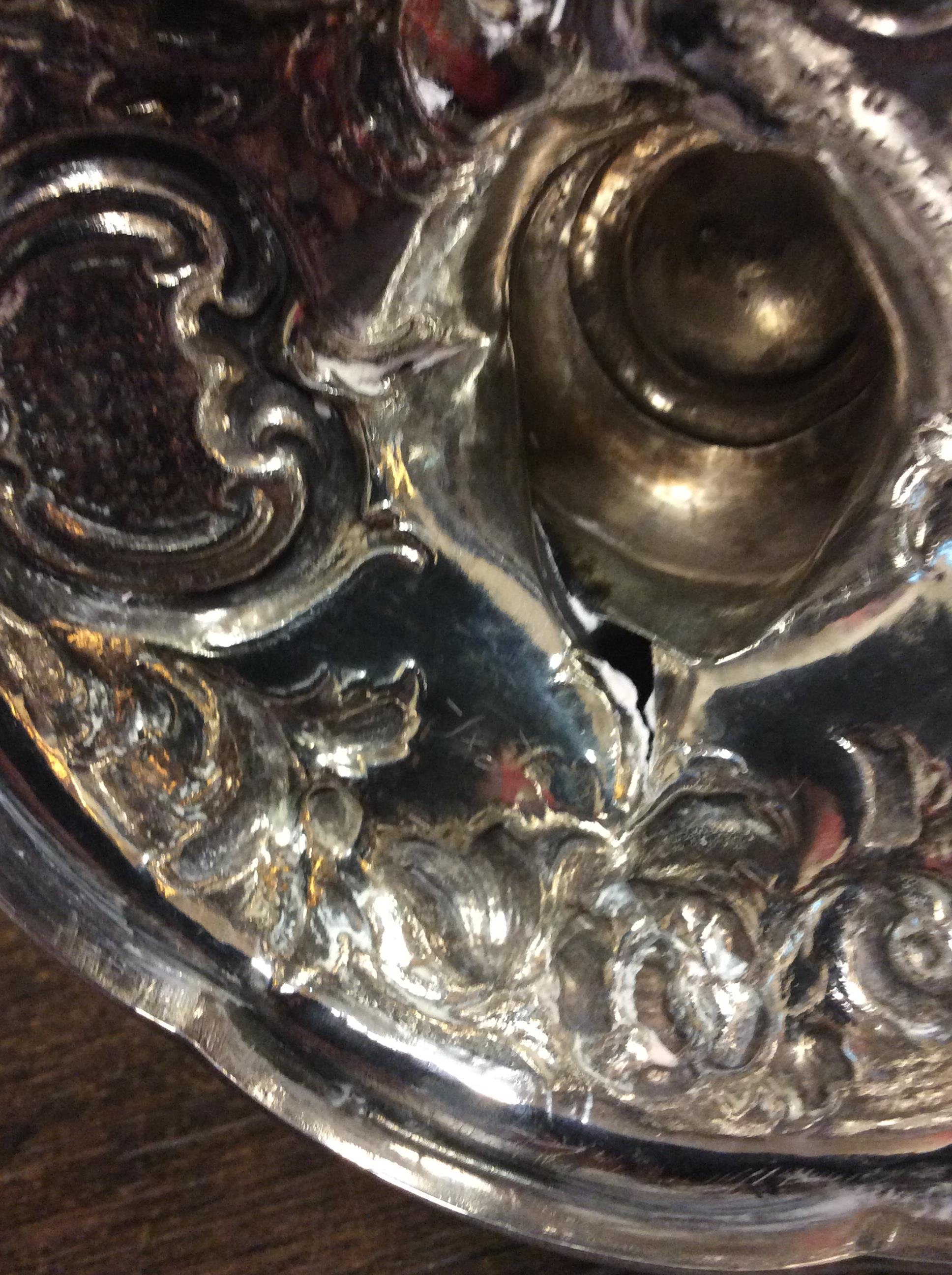 A VICTORIAN SILVER WATER JUG with repousse decoration and a scrolling handle on a circular base, - Image 3 of 10