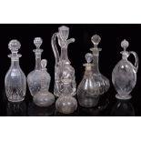 EIGHT CUT GLASS DECANTERS to include a selection of wine decanters including a cut glass mallet