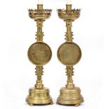 A PAIR OF GOTHIC STYLE BRASS TABLE LAMPS converted from candlesticks with pierced coronets,