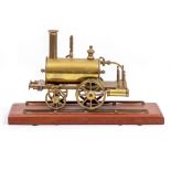 A BRASS MODEL STEAM TRACTOR on a mahogany base, 19cm wide x 16cm high