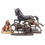 A BRONZED PLASTER SCULPTURE OF A PRANCING HORSE 41cm long x 39cm high together with two bronzed