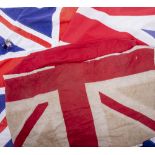 A GROUP OF SEVEN VINTAGE BRITISH FLAGS to include the Union flag and others, the largest