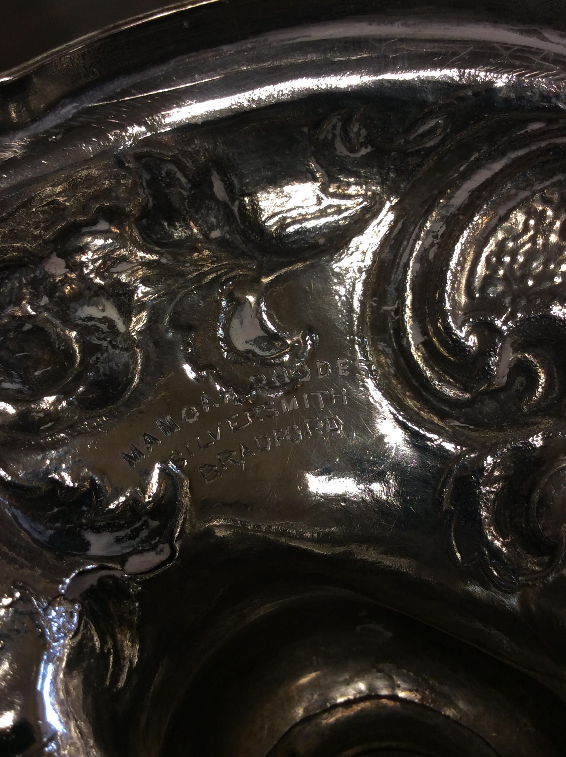 A VICTORIAN SILVER WATER JUG with repousse decoration and a scrolling handle on a circular base, - Image 8 of 10