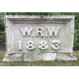 A VICTORIAN CARVED LIMESTONE DATE STONE with initials and date 1883, the plinth base 86cm wide and