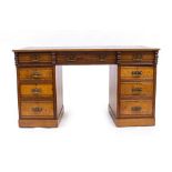 A LATE 19TH/EARLY 20TH CENTURY ARTS AND CRAFTS INFLUENCE BURR ASH AND OAK PEDESTAL DESK with a green