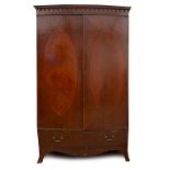 A MAHOGANY BOW FRONTED TWO DOOR WARDROBE with drawer beneath and outswept bracket feet, 122cm wide x